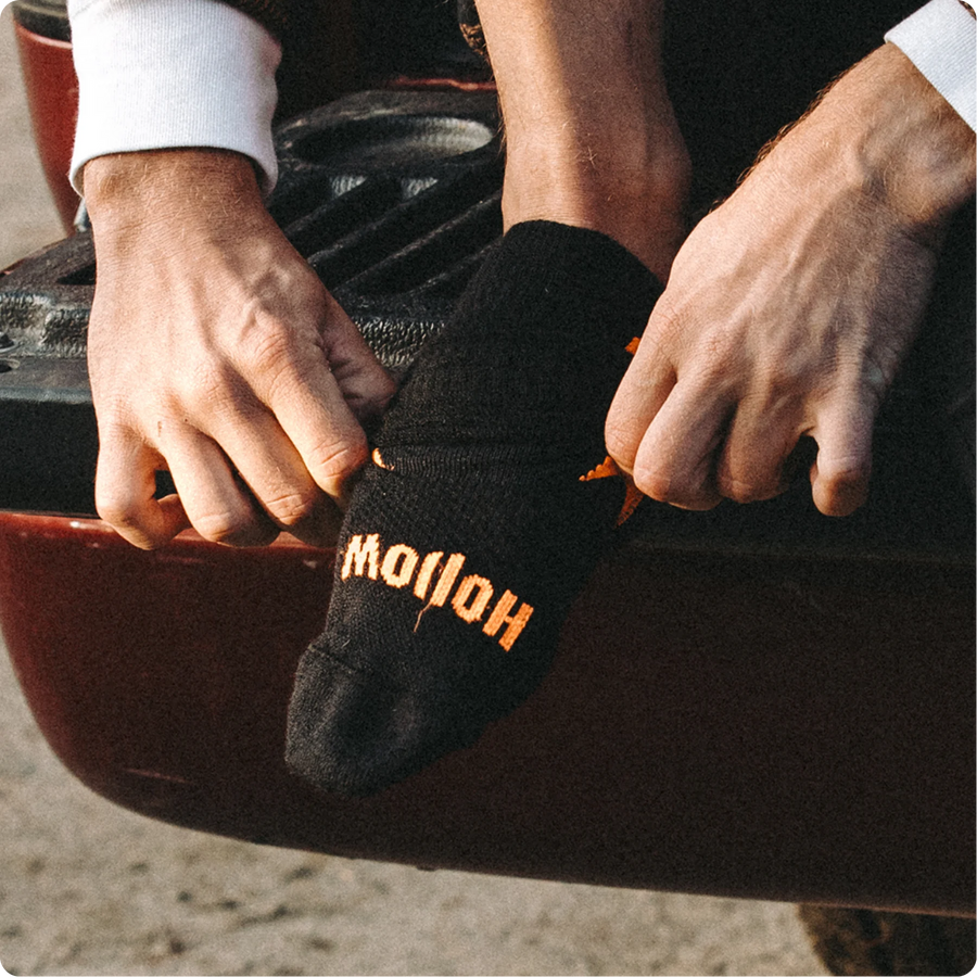 Guy putting Hunt socks showing how easy it is to put on
